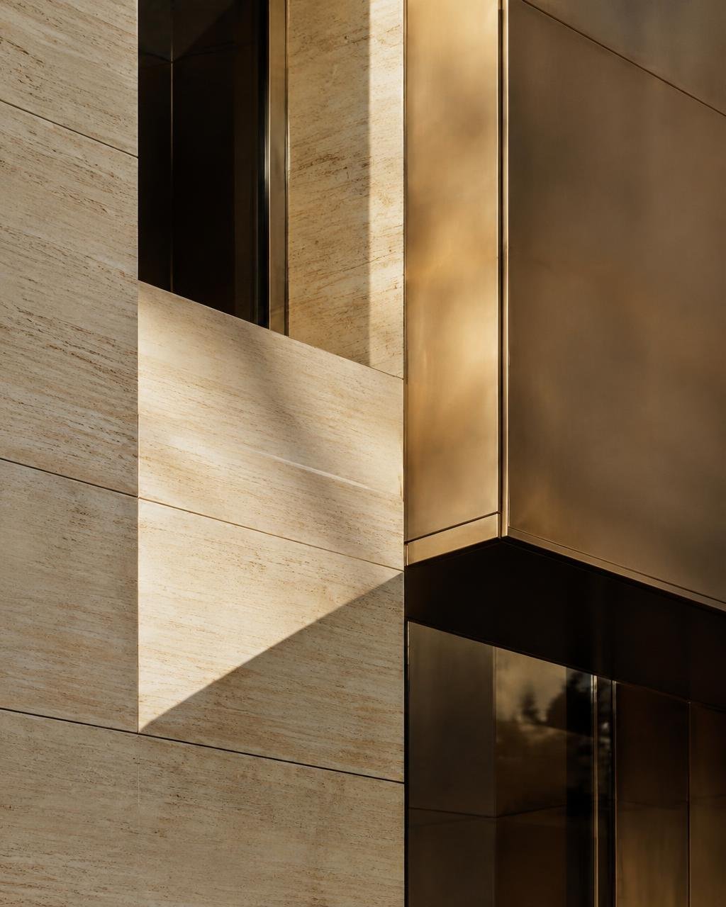 Architectural facade detail in travertine and bronze